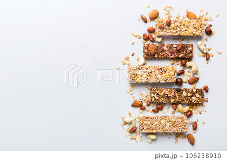 Various granola bars on table background. Cereal granola bars. Superfood breakfast bars with oats, nuts and berries, close up. Superfood concept 106238910