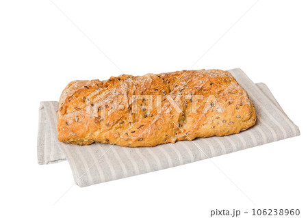 Freshly baked delicious french bread with napkin isolated on white background top view. Healthy white bread loaf 106238960