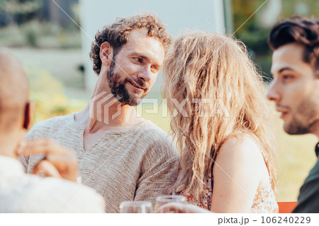 Lifestyle concept of a beautiful young couple in love seperating from their group of friends in the 106240229