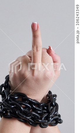 Female chained fist showing a fuck you sign Female chained fist showing a fuck you sign 106243349