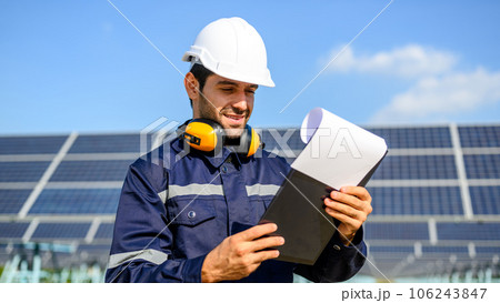 Technician worker installing solar panels at solar cell farm Technician worker installing solar panels at solar cell farm 106243847