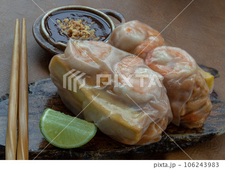 Homemade riceberry rice paper spring rolls stuffed with prawn), sliced chicke, tofu and egg served with sliced lime and chili sauce. Homemade riceberry rice paper spring rolls stuffed with prawn), sliced chicke, tofu and egg served with sliced lime and chili sauce. 106243983