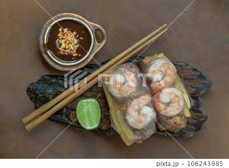 Homemade riceberry rice paper spring rolls stuffed with prawn, sliced chicken, tofu and egg served with sliced lime and chili sauce. Homemade riceberry rice paper spring rolls stuffed with prawn, sliced chicken, tofu and egg served with sliced lime and chili sauce. 106243985