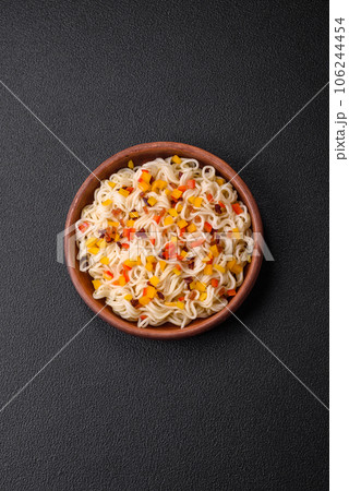 Delicious fresh Asian noodles with pieces of vegetables, meat, with salt, spices and herbs 106244454