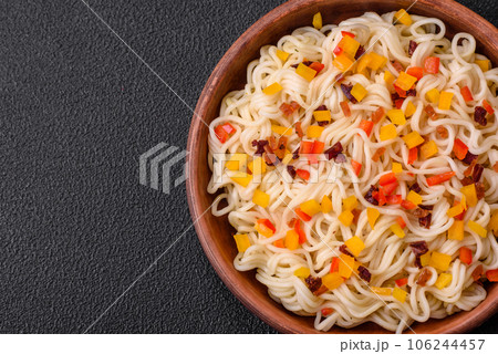 Delicious fresh Asian noodles with pieces of vegetables, meat, with salt, spices and herbs 106244457