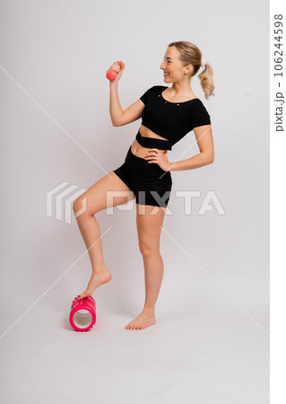 Full length portrait of smiling young woman in sportswear isolated over studio background. Full length portrait of smiling young woman in sportswear isolated over studio background. 106244598