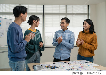 Asia team creative in smart casual wear discussing phone application design celebrate giving five after dealing feeling happy in office. Coworker teamwork concept Asia team creative in smart casual wear discussing phone application design celebrate giving five after dealing feeling happy in office. Coworker teamwork concept 106245179