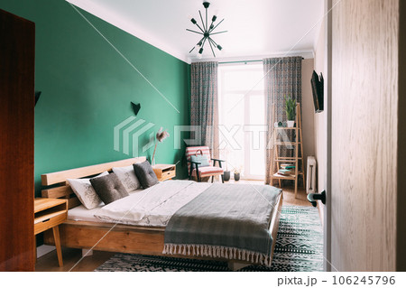 Modern Bright Bedroom's In Scandinavian Stylish. Family Apartment With Bright Green Wall And Wooden Designed Bed. Idea For Home Design. Light Colors Of Design. Stylish Apartment Interior Of Bedroom's 106245796