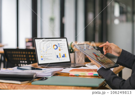 Happy smiling business woman working with laptop computer with paperwork at desk in a modern office, business finance technology concept. Happy smiling business woman working with laptop computer with paperwork at desk in a modern office, business finance technology concept. 106249813