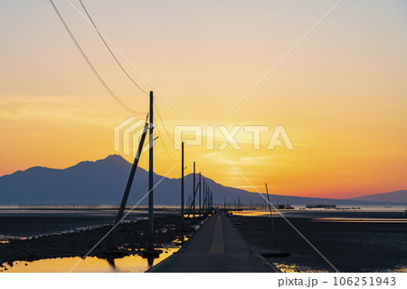 【熊本県】海に続く一本道 夕日に染まる長部田海床路 106251943