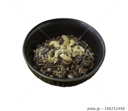 Homemade malt flakes cereal consists of rolled oats, cashew nuts, seeds, and honey in ceramic bowl isolated on white background with clipping path. Homemade malt flakes cereal consists of rolled oats, cashew nuts, seeds, and honey in ceramic bowl isolated on white background with clipping path. 106252498