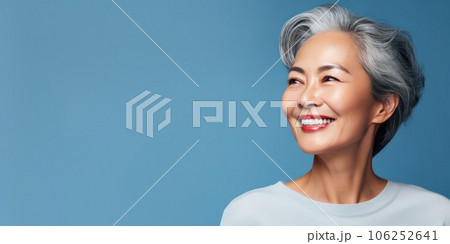Middle-aged Asian woman with a short gray hairdo looking at copy space. Middle-aged Asian woman with a short gray hairdo looking at copy space. 106252641