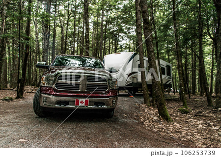 A pickup truck towing a camper RV trailer during summer time at Kejimkujik National Park Nova Scotia Canada A pickup truck towing a camper RV trailer during summer time at Kejimkujik National Park Nova Scotia Canada 106253739