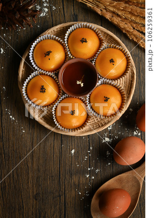 Traditional dessert for Chinese Mid-Autumn festival. Chinese pastry with stuffed salted yolk on wooden kitchen table Traditional dessert for Chinese Mid-Autumn festival. Chinese pastry with stuffed salted yolk on wooden kitchen table 106259361