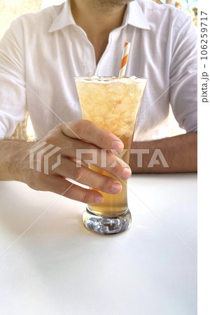 man drinking refreshing drink in a bar man drinking refreshing drink in a bar 106259717