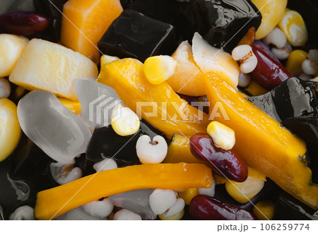 Close-up of Black Grass Jelly is including Nuts, Cereals, Red beans, Ginkgo, Pumpkin, Corn kernels, Millet, Sweet potato, Palm seed and Jelly. 106259774