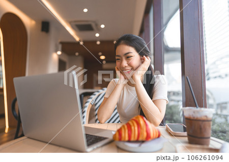 Asian woman relax cafe with laptop sitting near window indoors on day city people modern lifestyles Asian woman relax cafe with laptop sitting near window indoors on day city people modern lifestyles 106261094