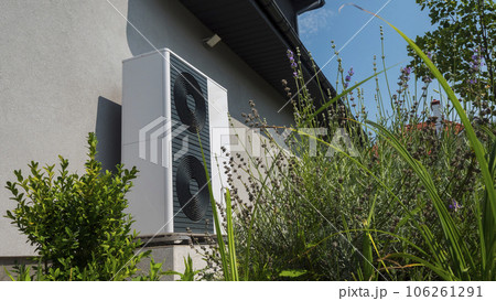 External heat pump unit against the wall of the house. Modern technologies for energy saving External heat pump unit against the wall of the house. Modern technologies for energy saving 106261291