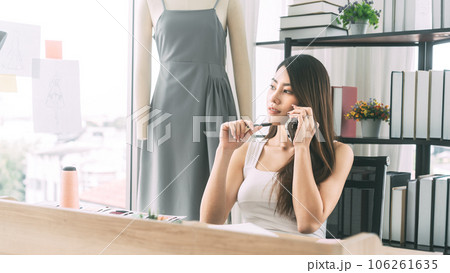 Asian woman designer busy making clothes work or study in fashion design studio 106261635