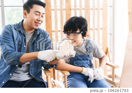 Southeast asian family father and son talking together at home workshop office 106261783