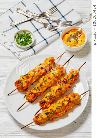Bang Bang Chicken Skewers on plate, top view 106263424