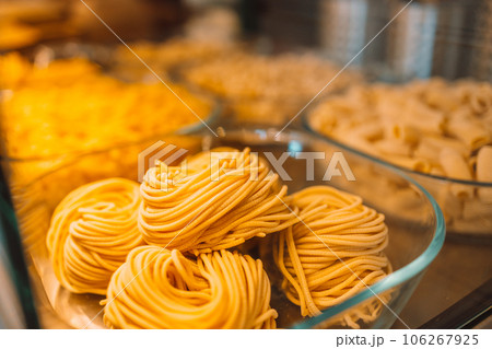 Traditional Italian fresh made colorful organic pasta in shop window. Italian food at a farmer's market in Pisa, Italy.  106267925