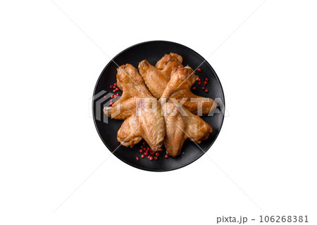 Baked chicken wings with salt, spices and herbs 106268381