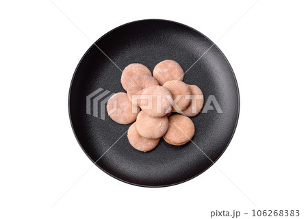 Delicious fresh baked cornmeal shortcakes or cookies on a black plate 106268383