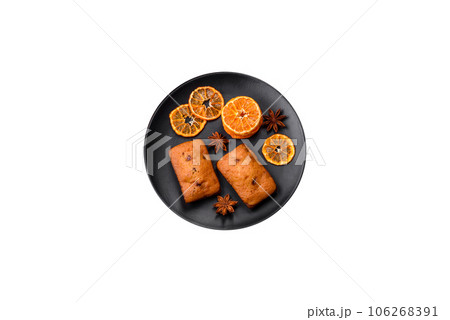 Delicious chocolate muffins and dried round shaped slices of tangerine Delicious chocolate muffins and dried round shaped slices of tangerine 106268391