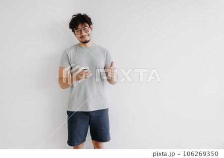 Bored face man feeling happy with the application in mobile phone. Bored face man feeling happy with the application in mobile phone. 106269350