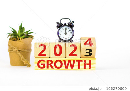 Planning 2024 growth new year symbol. Businessman turns a wooden cube and changes words Growth 2023 to Growth 2024. Beautiful white background, copy space. Business 2024 growth new year concept. 106270809