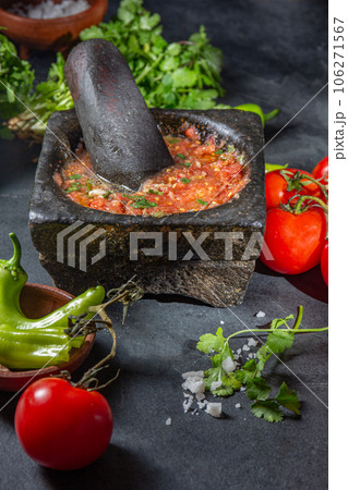Traditional Latin American mexican Tomato sauce salsa, chilean chancho en piedra in stone mortar Traditional Latin American mexican Tomato sauce salsa, chilean chancho en piedra in stone mortar 106271567