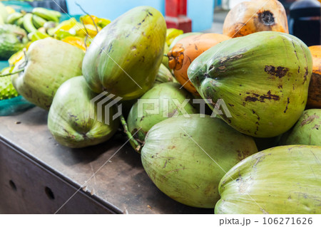 Green coconuts are on a counter at local marketplace Green coconuts are on a counter at local marketplace 106271626
