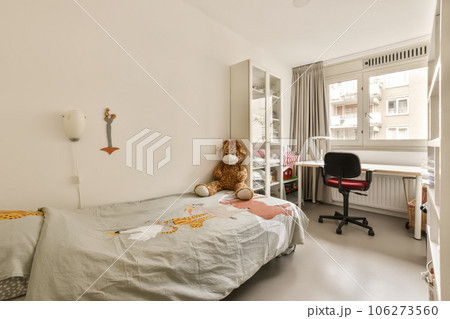 a child's room with a bed, desk and window in the corner to the right is an office a child's room with a bed, desk and window in the corner to the right is an office 106273560