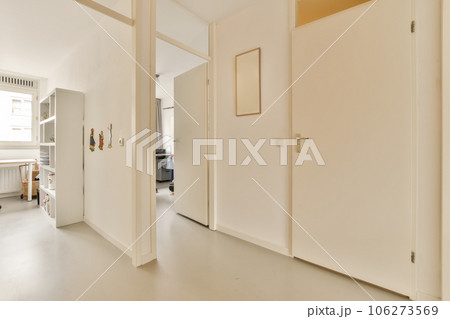 an empty room with white walls and door handles on the doors are closed to let in light into the room 106273569
