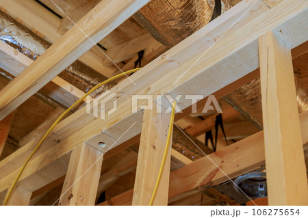 Construction essence interior view of new unfinished house with wooden beams frame 106275654