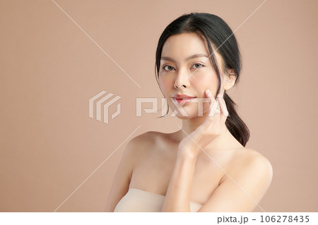 Beautiful young asian woman with clean fresh skin on beige background, Face care, Facial treatment, Cosmetology, beauty and spa, Asian women portrait. 106278435