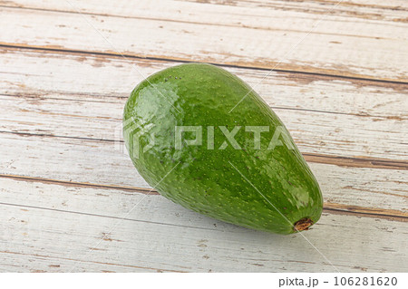 Ripe green avocado over background 106281620