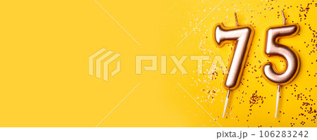 75 years celebration. Greeting banner. Gold candles in the form of number forty on yellow background with confetti. 75 years celebration. Greeting banner. Gold candles in the form of number forty on yellow background with confetti. 106283242