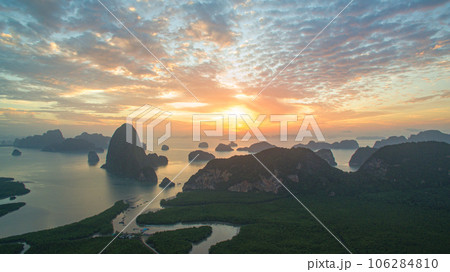 aerial view Amazing light of nature cloudscape sky above Samed Nang Chee Phang Nga archipelago.  Imagine a fantasy bright red sky at sunrise from a bird's eye view. tropical landscape background. 106284810