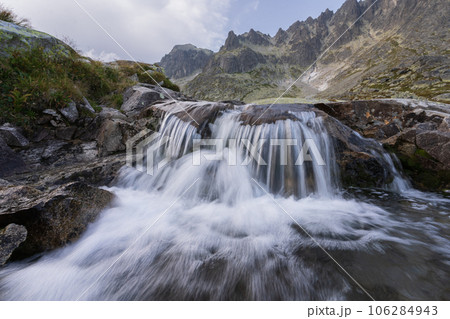 Beautiful alpine landscape with foreground waterfall and background rocky peaks, Slovakia, Europe 106284943