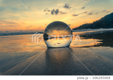 Magnificent sky above the crystal ball on the beach..The beautiful reflection of the sky above the crystal ball on the wet sand beach..Unique and creative travel and nature idea 106285009