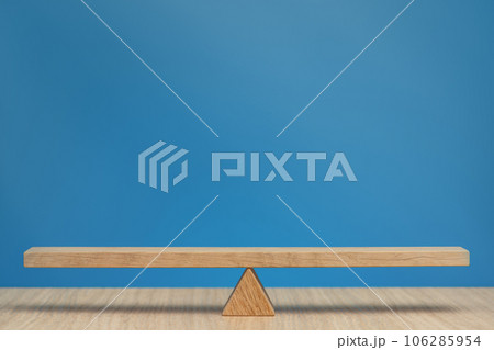 Empty wooden scales on a blue background. The concept of equilibrium and balance. High quality photo with copy space. 106285954