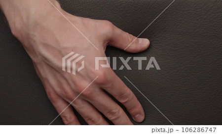 Closeup man checking leather quality on furniture 106286747