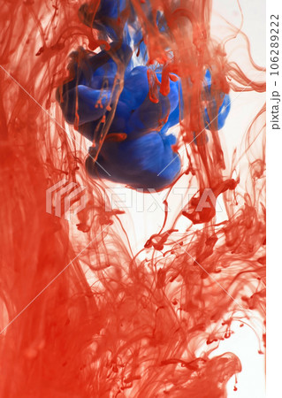 Orange and blue paints dissolve in water, white isolated background. Abstraction in motion, colorful ink circulate in the water Orange and blue paints dissolve in water, white isolated background. Abstraction in motion, colorful ink circulate in the water 106289222