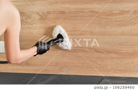 Concept of home cleaning and steam disinfection of the surface. Steam cleaning kitchen worktops with hot steam. Selective focus with copy space. 106289460