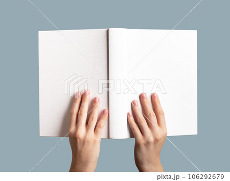 Hands holding open book mock up, blank empty hard cover, hardcover mockup Hands holding open book mock up, blank empty hard cover, hardcover mockup 106292679