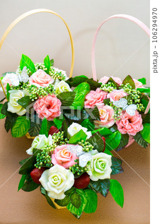 Three handmade soap bouquets in the form of roses, clarkia and strawberries on a white background Three handmade soap bouquets in the form of roses, clarkia and strawberries on a white background 106294970