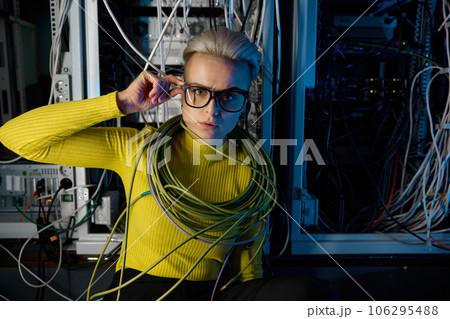 Portrait of tired overwhelmed female IT engineer at server room 106295488