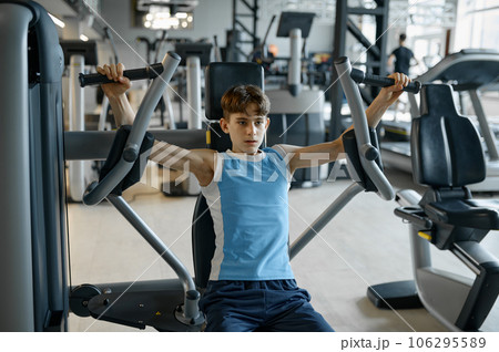 Active teenager boy doing physical exercise for masculinity development 106295589